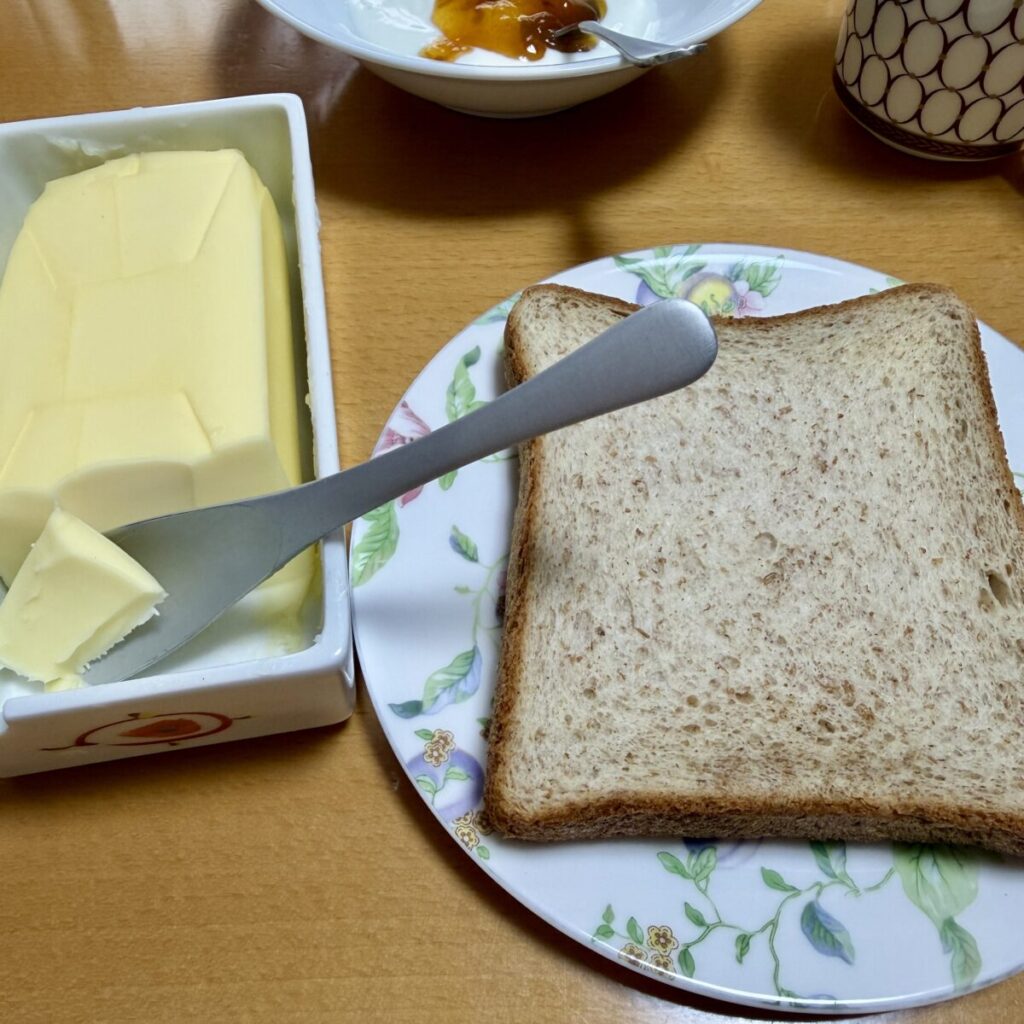 麦のめぐみ全粒粉入り食パン6枚をトーストしてバターを塗って皿に盛り付けた画像